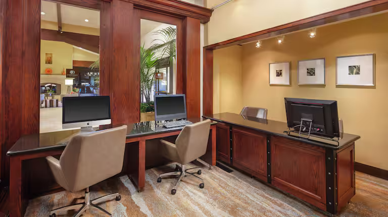Hotel business center with desks and computers