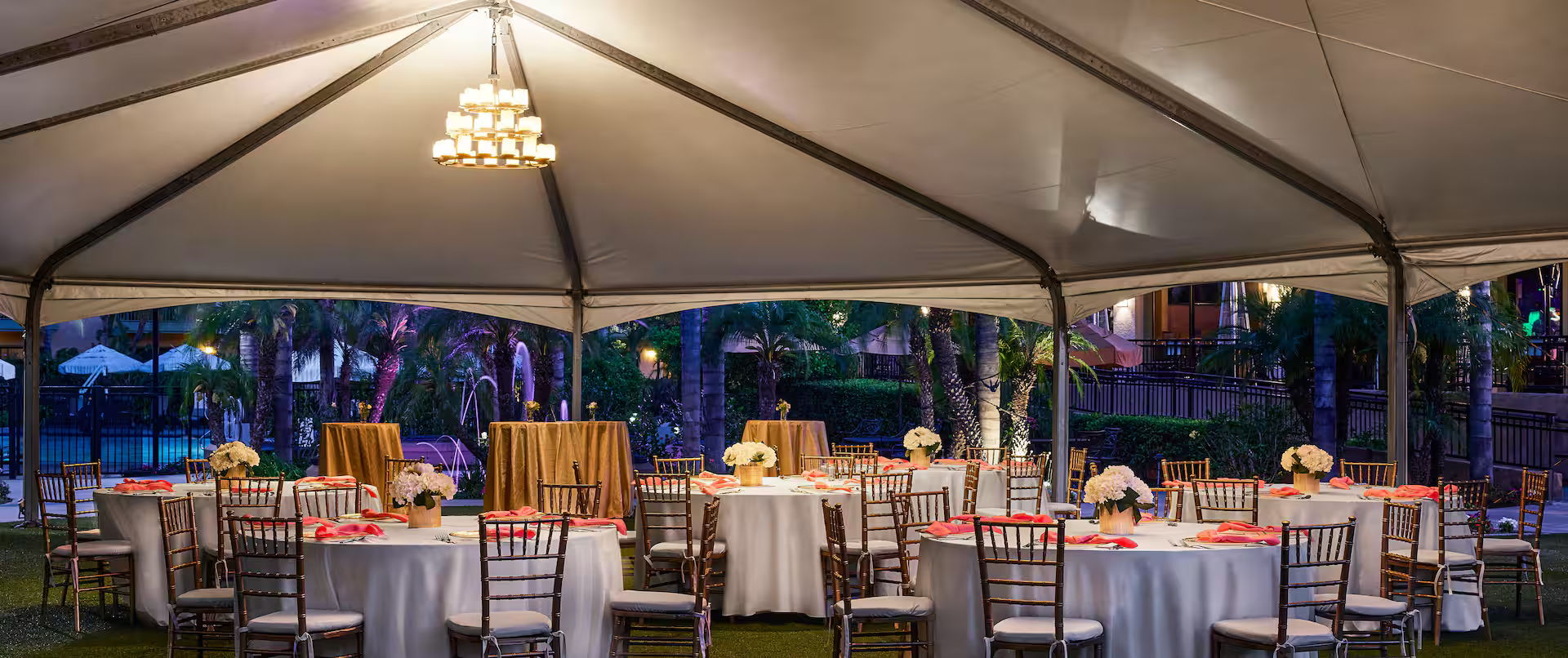 Elegant white-tented courtyard reception at night