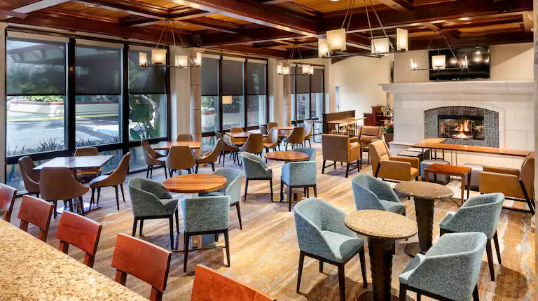 Warm hotel lounge with fireplace and conversational seating